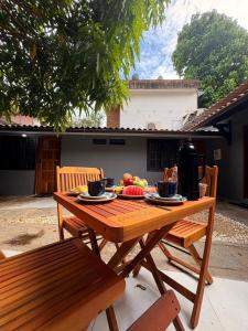 a wooden table with plates of food on it at Brisamar Suítes Ilha Grande in Angra dos Reis
