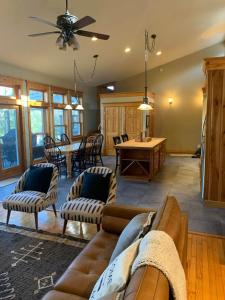 a living room with a couch and a table at Private Lakefront with Dock! in Bethel