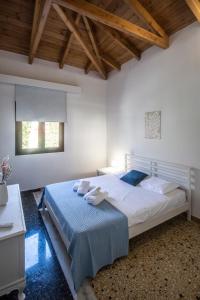 a bedroom with a bed with towels on it at Αριάδνη in Archanes