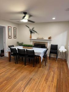 a dining room with a table and chairs and a fireplace at Fun 5 Bedroom Lakefront Cottage in Bethel