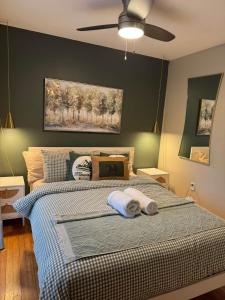 a bedroom with a bed with a ceiling fan at Fun 5 Bedroom Lakefront Cottage in Bethel
