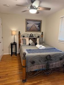 a bedroom with a bed with a ceiling fan at Fun 5 Bedroom Lakefront Cottage in Bethel