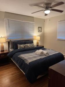 a bedroom with a bed with a ceiling fan at Fun 5 Bedroom Lakefront Cottage in Bethel +8 photos