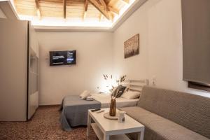 a living room with a couch and a table at Αριάδνη in Archanes