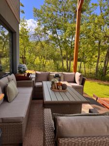an outdoor patio with couches and a table at Chatka in Roztiezi in Roztěž