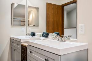 a bathroom with two sinks and a mirror at Seasons Alpine Retreat in Avon +40 photos