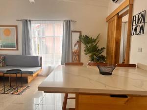 a living room with a table and a couch at Villa Paradise in Jacó