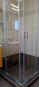 a shower with a glass door in a bathroom at Ionian Casa Azul in Karavomylos +16 photos