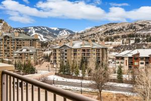 a view from the balcony of a resort with snow covered mountains at Seasons Alpine Retreat in Avon
