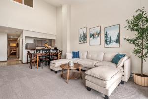 a living room with a couch and a table at Seasons Alpine Retreat in Avon