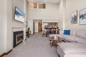 a living room with a couch and a fireplace at Seasons Alpine Retreat in Avon
