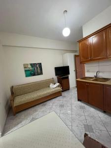 a living room with a couch and a kitchen at City Center Hotel in Sarandë +30 photos