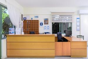 an office with a reception desk with two chairs and a desk at Nikolas Villas Appartments in Hersonissos +31 photos