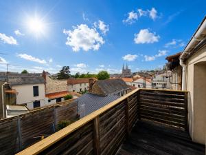 a balcony with a view of a city at Les terrasses de la moine in Cholet