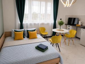 a bedroom with a bed and a table and chairs at Powidz Comfort Suites in Powidz