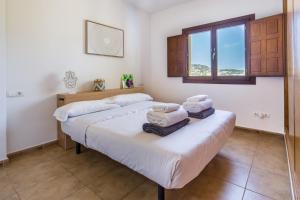 a bedroom with two beds and a window at Can Rusiniol 2 in Puig D’en Valls +20 photos