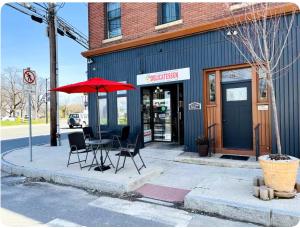a table and chairs on a sidewalk in front of a store at Cabin Experience near all in Wilkes-Barre