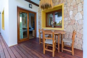 a wooden table and chairs on a deck at Can Rusiniol 2 in Puig D’en Valls
