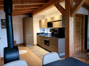 a kitchen with a stove top oven next to a counter at Portes du Soleil T3 "comme un chalet" direct access Morzine Avoriaz in Montriond
