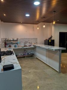 a large kitchen with a counter and a sink at Estancia Mirador Reyes- Casa de la Montaña in Zamora
