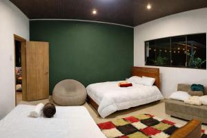 a bedroom with two beds and a green wall at Estancia Mirador Reyes- Casa de la Montaña in Zamora +29 photos