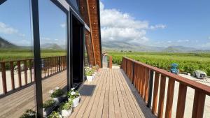 a balcony with potted plants and a view of the mountains at Konispol Mandarin Cabin in Mursi +16 photos