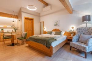 a bedroom with a bed and a desk and a chair at Kreuzwegerhof Nals - Historic Nature Stay with Pool near Meran & Bozen in Nalles +113 photos