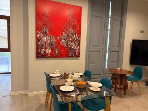 ein Esszimmer mit Tisch und Stühlen und einem Gemälde in der Unterkunft Hotel Ginebra in Barcelona