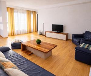 a living room with a couch and a coffee table at Adori Boutique in Eforie Nord