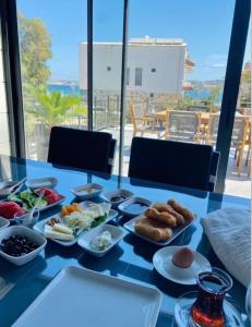 a blue table with plates of food on it at Bacbery Butik Otel in Çeşme