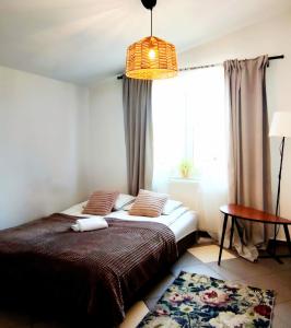 a bedroom with a bed and a window at ViLLA IVET in Gdańsk