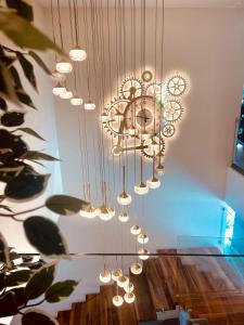 a chandelier hanging over a table in a room at EBBI HOTEL in Dhërmi