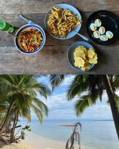 two plates of food on a table on a beach at Boca Estrella in Bocas Town