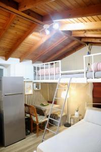 a dorm room with bunk beds and a table at The Nest in Astris