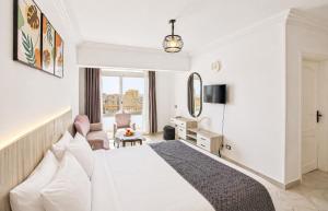 a hotel room with a bed and a desk at Nile X Hostel - Nile view in Cairo