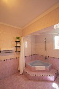 a large bathroom with a tub in a room at Nile X Hostel - Nile view in Cairo +45 photos