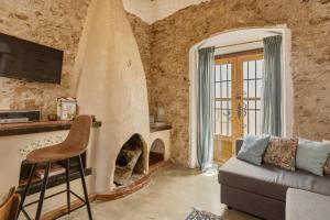 a living room with a couch and a fireplace at The Farm Lodge in Marbella