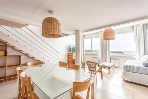 a living room with a glass table and chairs at Cariló Forest in Carilo