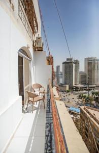 a bench sitting on the balcony of a building at Nile X Hostel - Nile view in Cairo