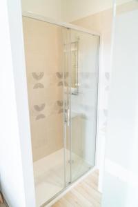 a glass shower stall in a room with at Parnaydisiaque in Parnay