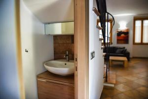 a bathroom with a sink on top of a counter at Roncati Family Apartment in Bellagio +39 photos