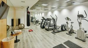 a gym with treadmills and elliptical machines at Sercotel Caspe in Barcelona