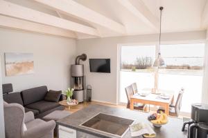 a living room with a couch and a table at Ferienhaus Brückenblick 12 a in Fehmarnsund