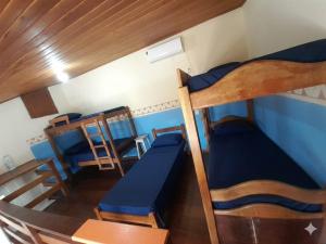 a small room with two bunk beds and a table at Hostel IndiaJara in Itacaré