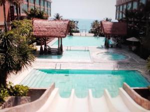 a swimming pool in the middle of a building at Aura Seaviews Suites in Phan Thiet