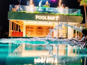 a pool bar at a resort at night at Aura Seaviews Suites in Phan Thiet