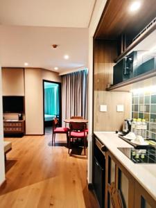 a kitchen with a table and a dining room at Aura Seaviews Suites in Phan Thiet +4 photos
