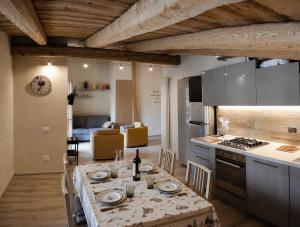 a kitchen and living room with a table and a stove at Villa Rostagno in Entracque
