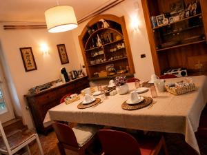 a dining room table with a white table cloth at Casa Zarabara in Arta Terme