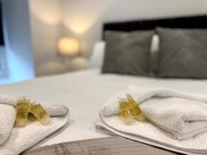 a pair of towels on a bed with weights on them at Central 3BR home with Parking in Aberdeen